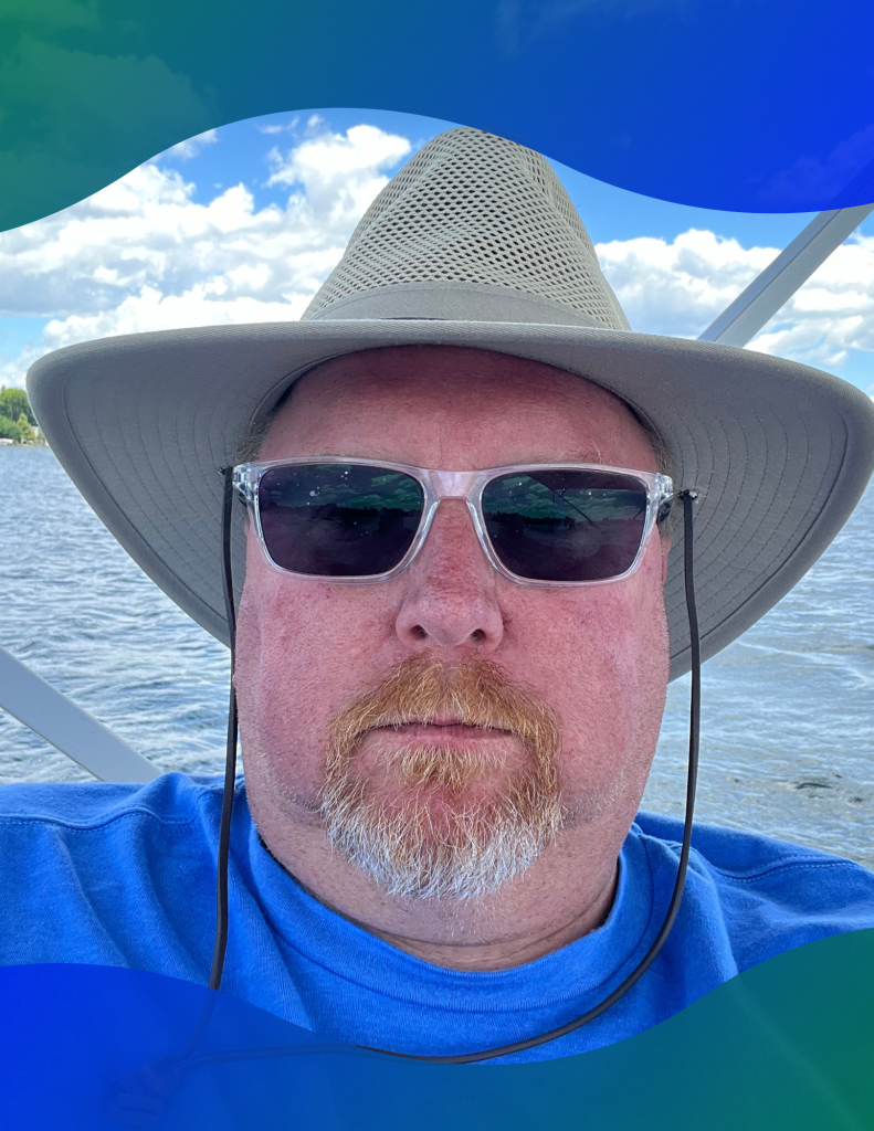 Greg Graham sits on a boat during one of his family vacations